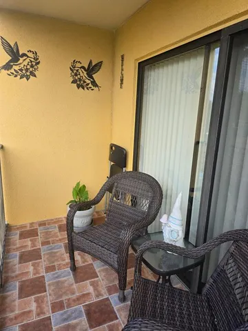 a view of a balcony with furniture