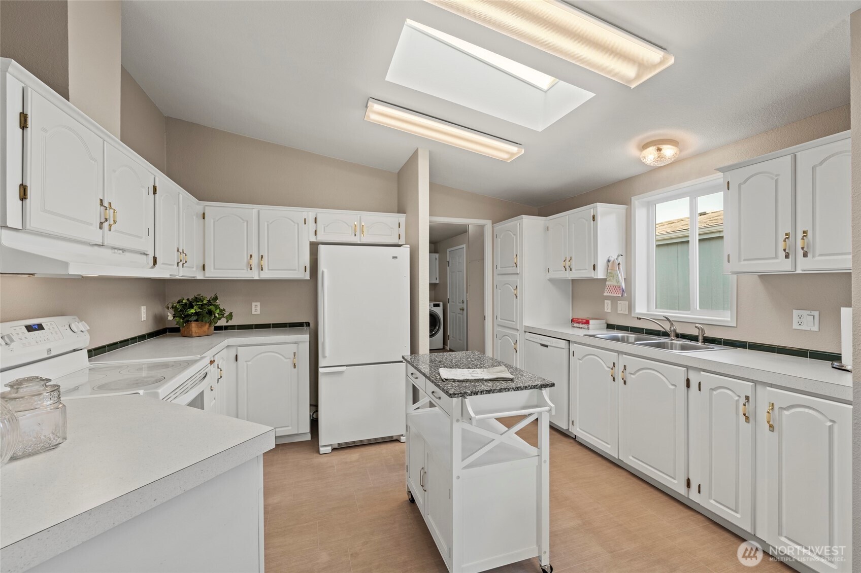 23825 15th Avenue Southeast, Unit 108 Bothell, WA 98021 - Photo 11 of 39 a kitchen with white cabinets sink and white appliances