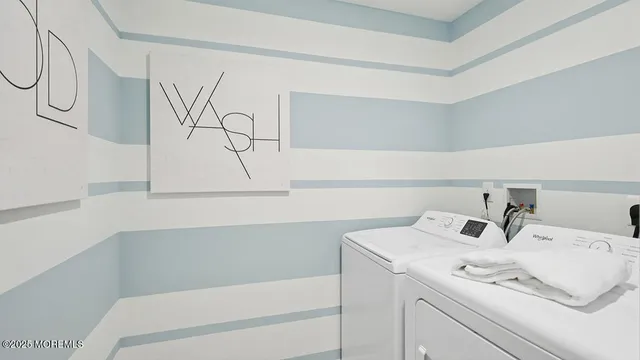 a bedroom with a bed a chandelier and mirror on the dresser