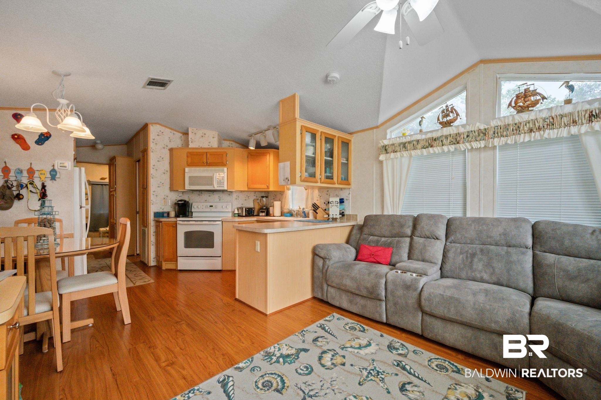 24711 County Road 20, Unit A11 Elberta, AL 36530 - Photo 6 of 35 Living room featuring lofted ceiling, ceiling fan, and light wood-type flooring