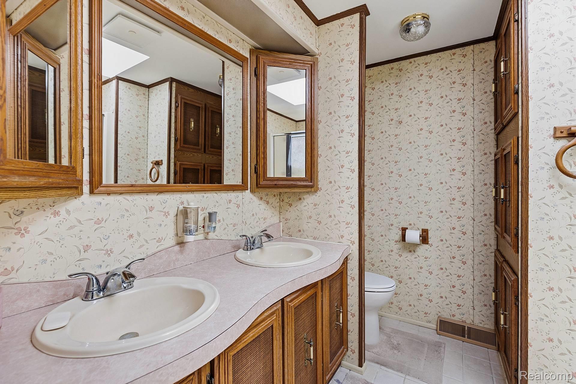 70919 Coon Creek Road Armada, MI 48005 - Photo 20 of 50 Full bath with double vanity, ornamental molding, wallpapered walls, and light tile patterned floors