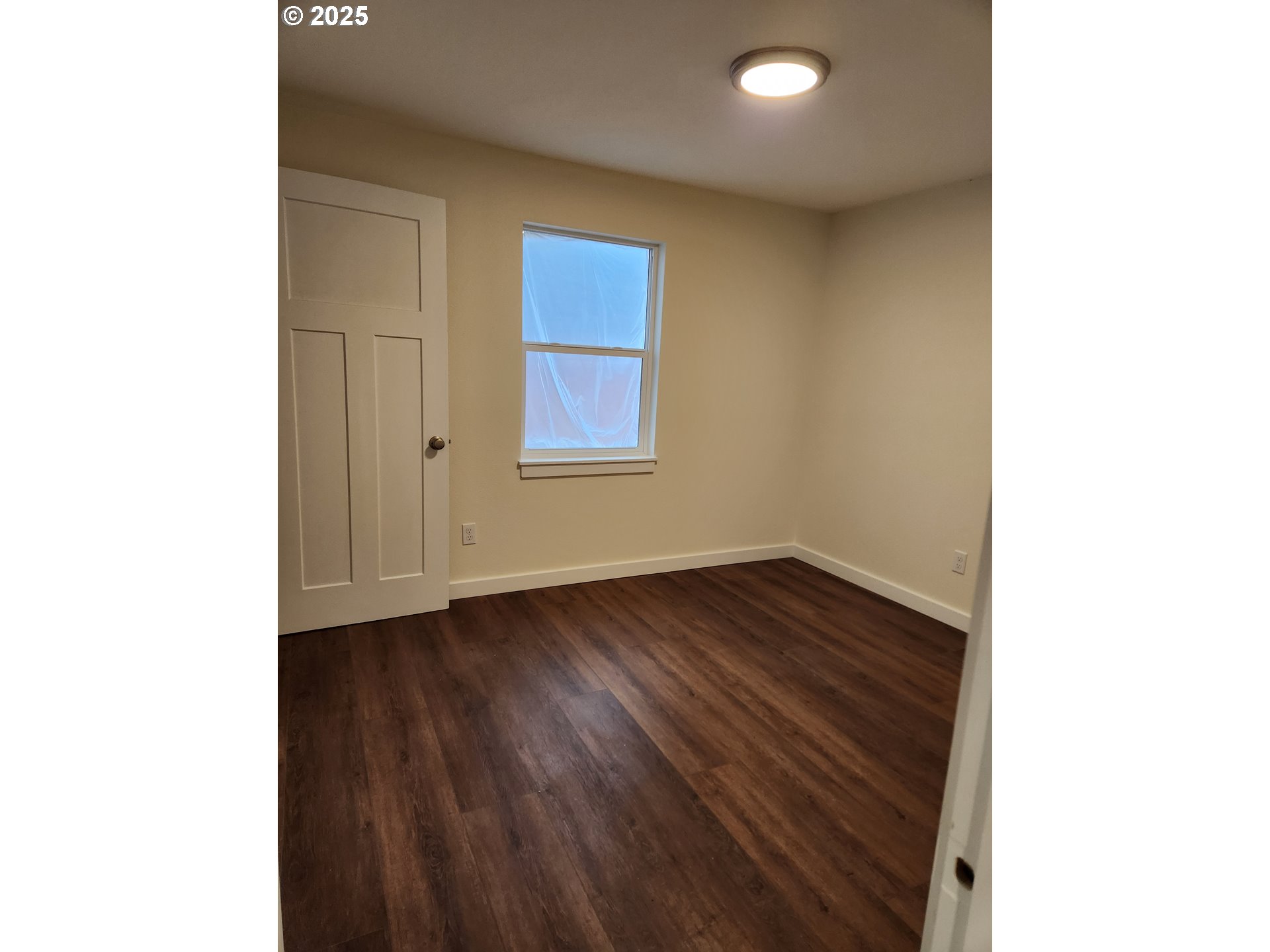 2604 J Street Springfield, OR 97477 - Photo 7 of 11 a view of an empty room with wooden floor and a window