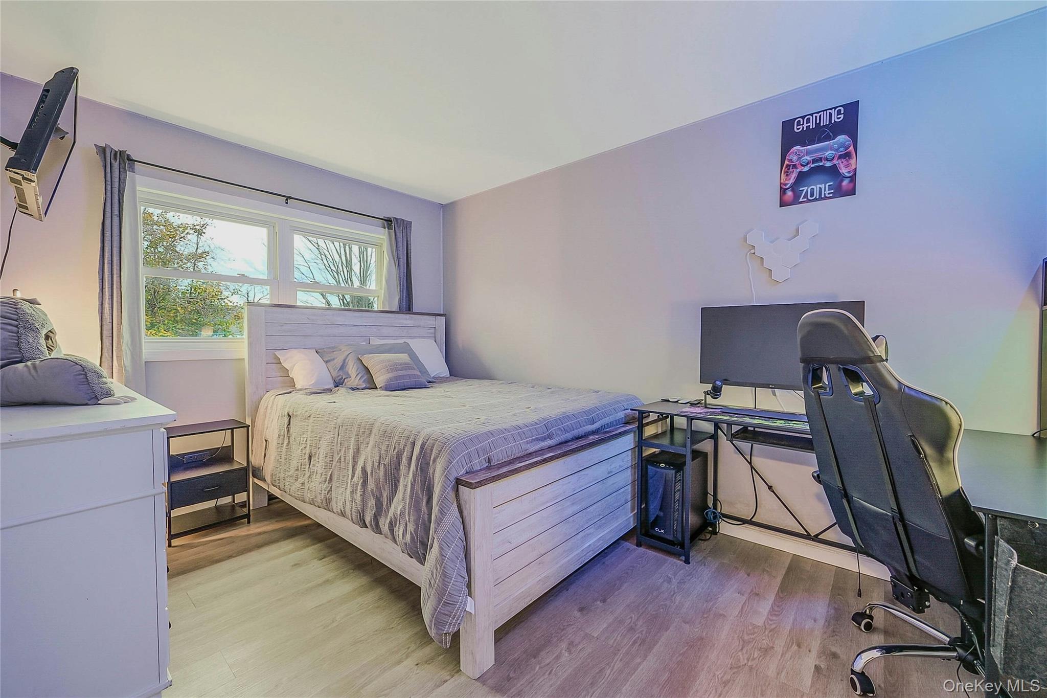 425 Blue Point Road Farmingville, NY 11738 - Photo 13 of 32 a bedroom with a bed and a desk