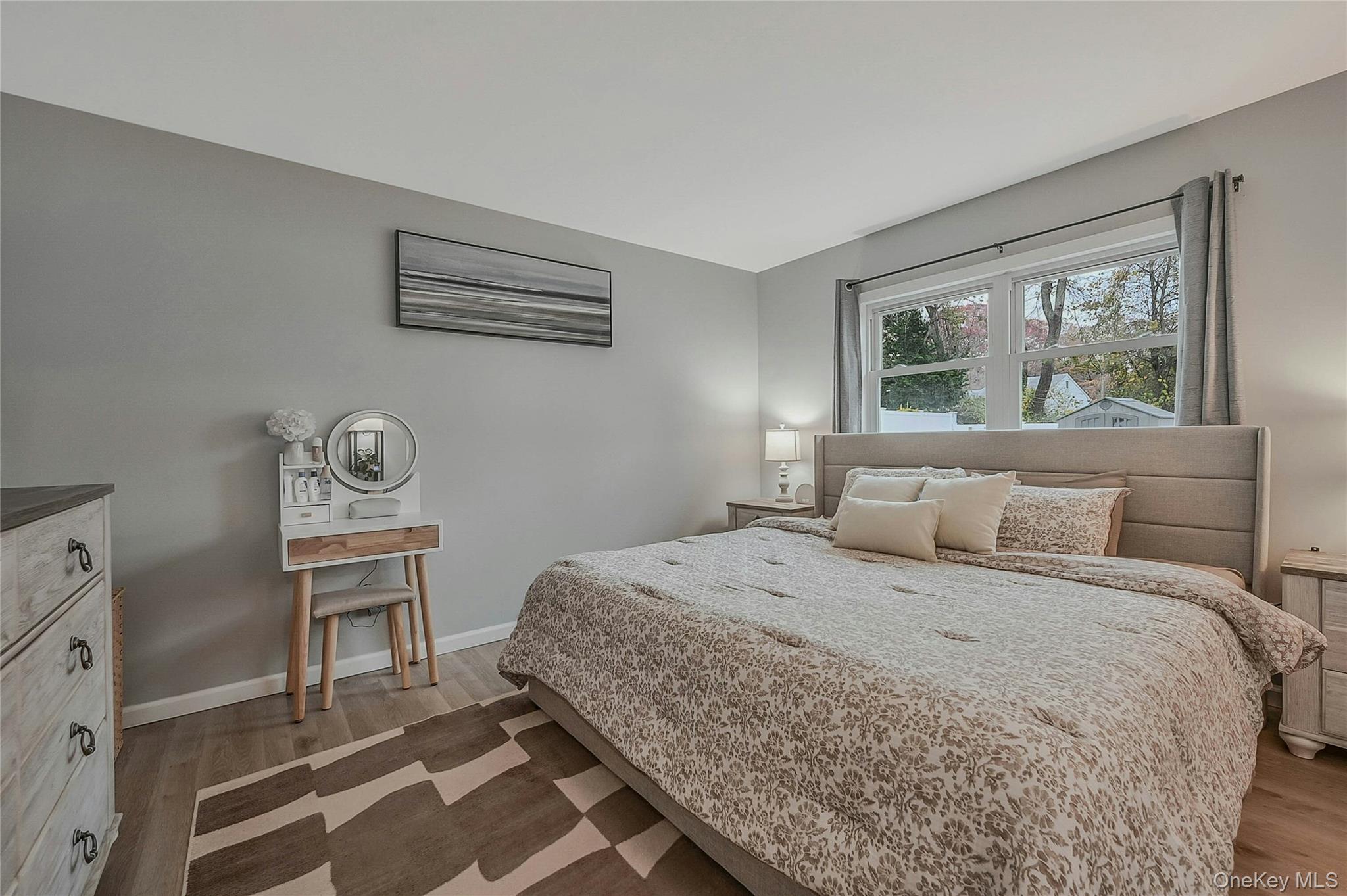 425 Blue Point Road Farmingville, NY 11738 - Photo 16 of 32 a bedroom with a bed and a dresser next to a window