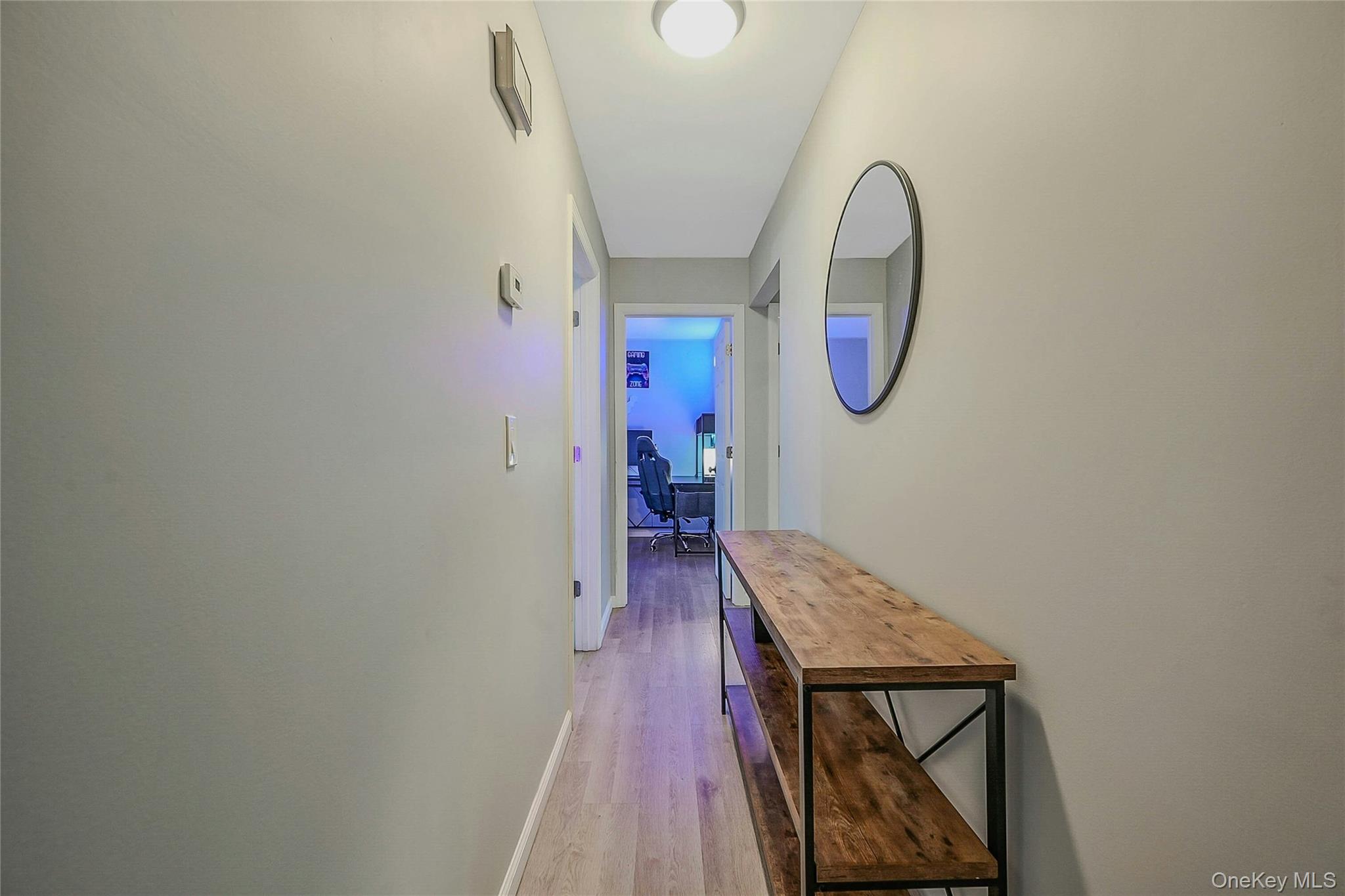 425 Blue Point Road Farmingville, NY 11738 - Photo 18 of 32 a view of a hallway with wooden floor and mirror