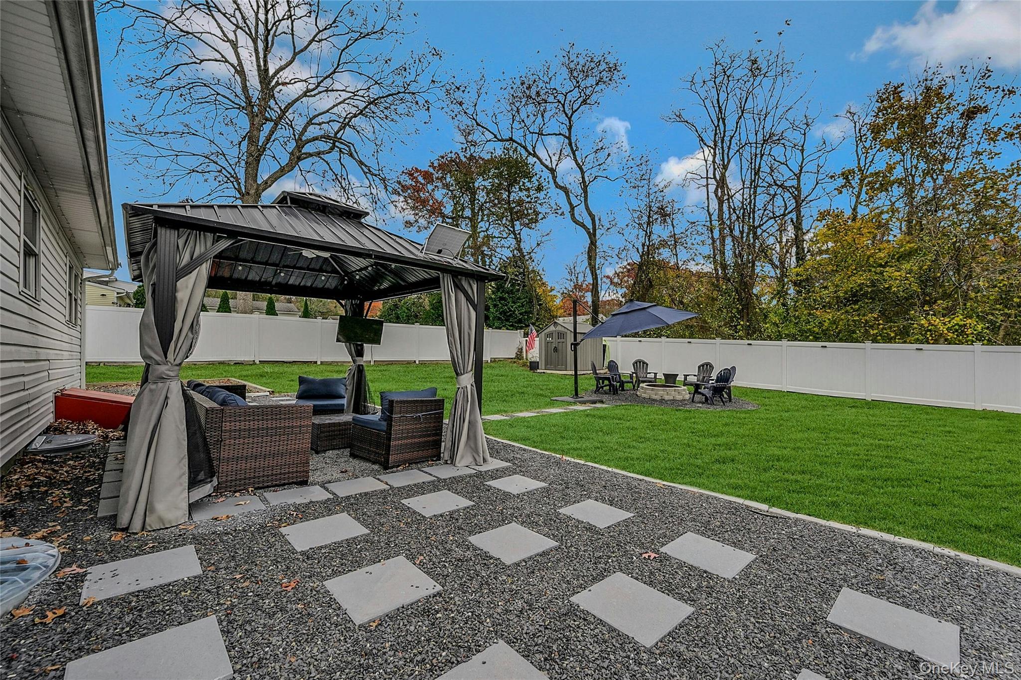 425 Blue Point Road Farmingville, NY 11738 - Photo 22 of 32 a view of a patio with table and chairs potted plants with wooden floor