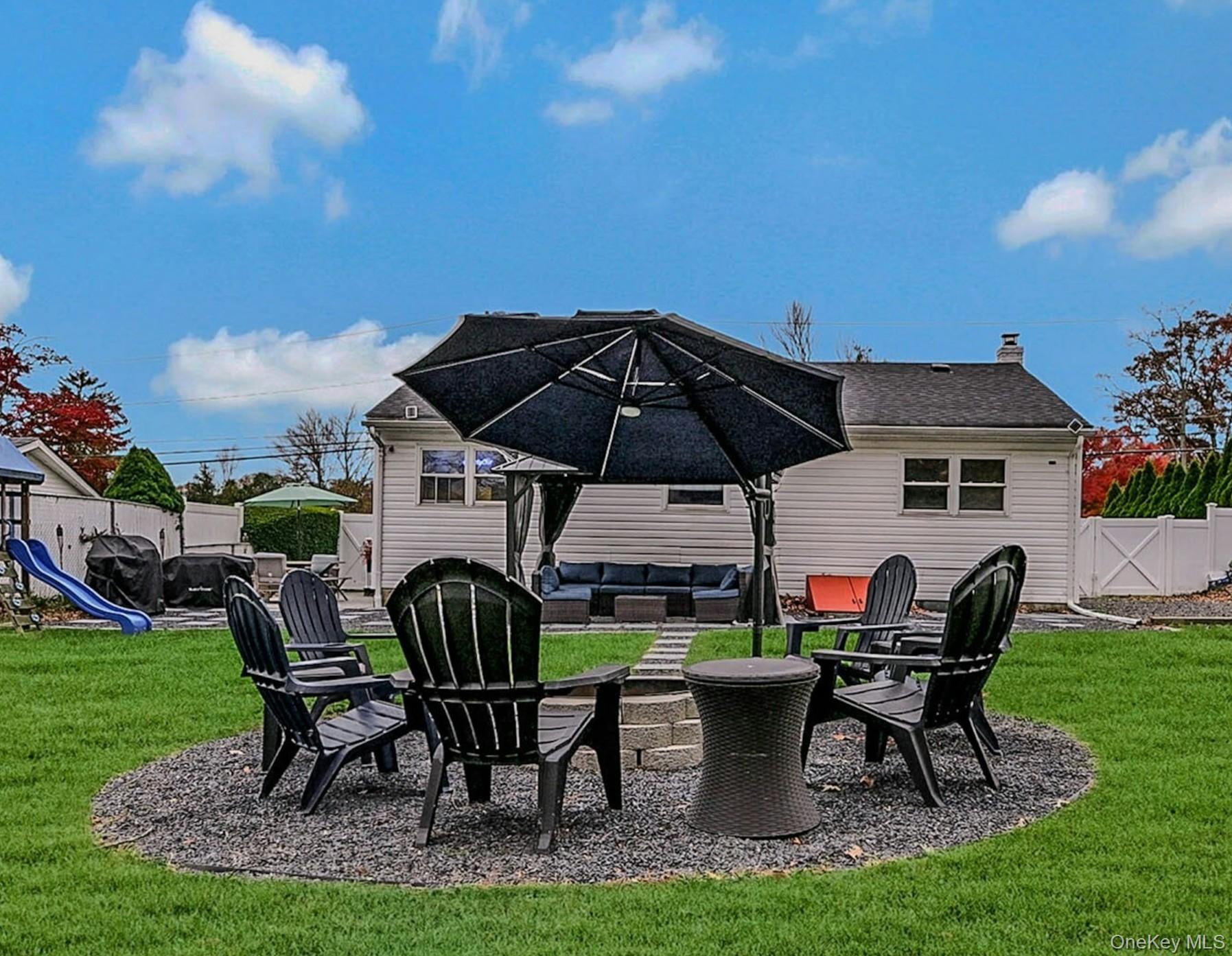 425 Blue Point Road Farmingville, NY 11738 - Photo 23 of 32 a view of backyard of house with seating space