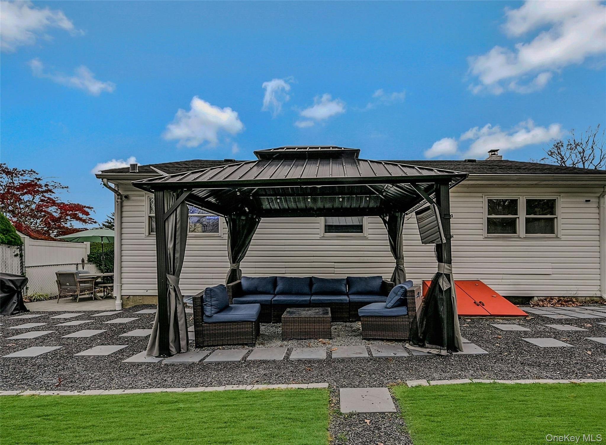 425 Blue Point Road Farmingville, NY 11738 - Photo 25 of 32 a backyard of a house with barbeque oven table and chairs