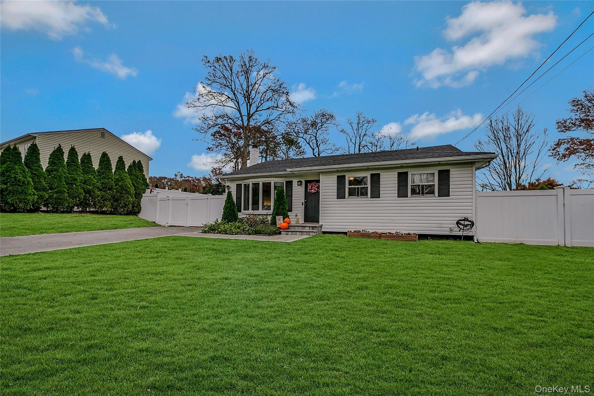 425 Blue Point Road Farmingville, NY 11738 - Photo 4 of 32 a front view of a house with a garden