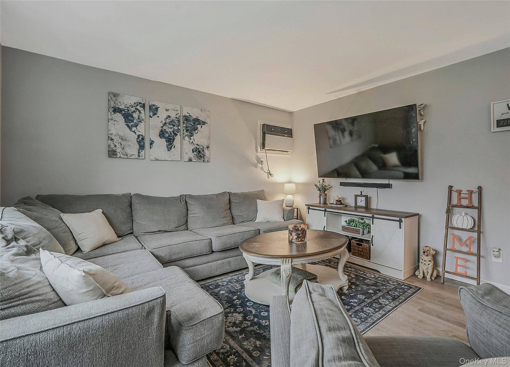 425 Blue Point Road Farmingville, NY 11738 - Photo 5 of 32 a living room with furniture and a flat screen tv