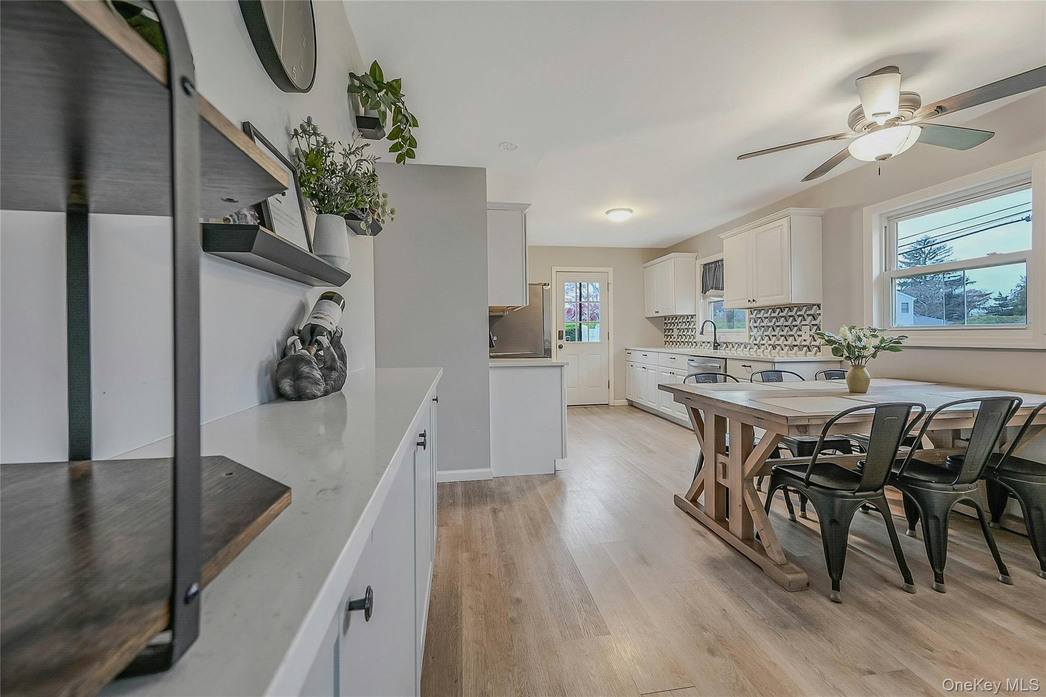425 Blue Point Road Farmingville, NY 11738 - Photo 7 of 32 a view of a dining room with furniture and wooden floor