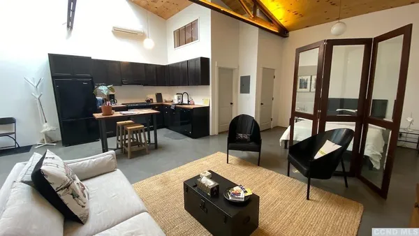 a living room with furniture and a piano