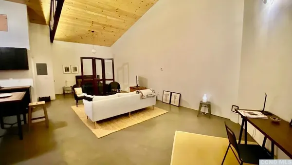 a view of workspace with wooden floor and windows