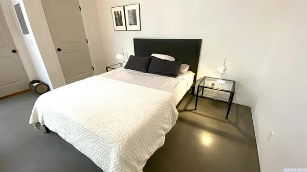 a bed sitting in a bedroom next to a window