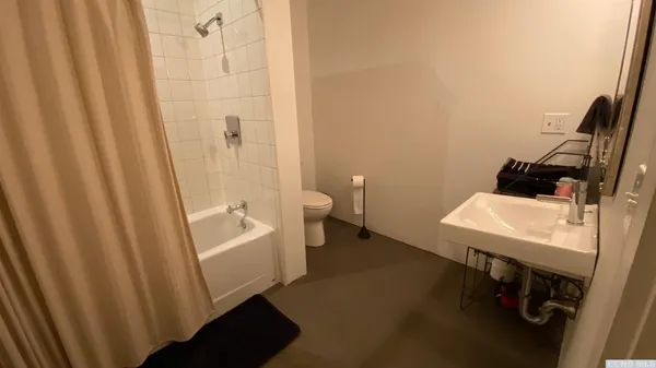 a bathroom with a bathtub and a toilet