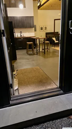 a backyard of a house with barbeque oven table and chairs