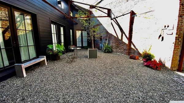 a view of a house with potted plants