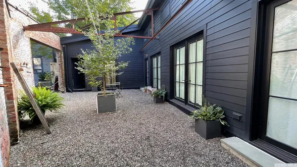 a view of a house with a backyard and sitting area
