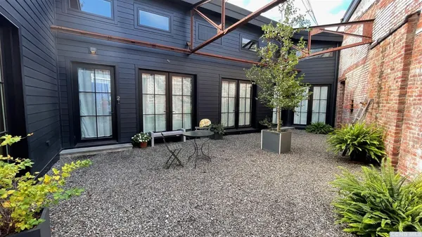 a backyard of a house with table and chairs