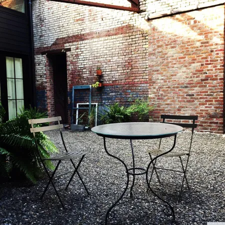 a view of a brick building with potted plants