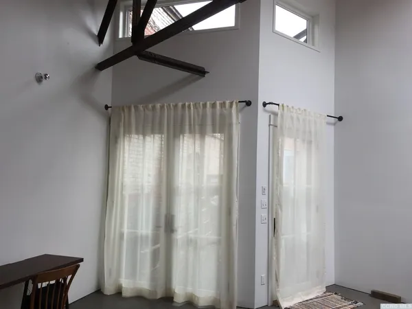 a view of a room with staircase and door