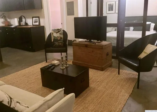 a living room with furniture and a flat screen tv