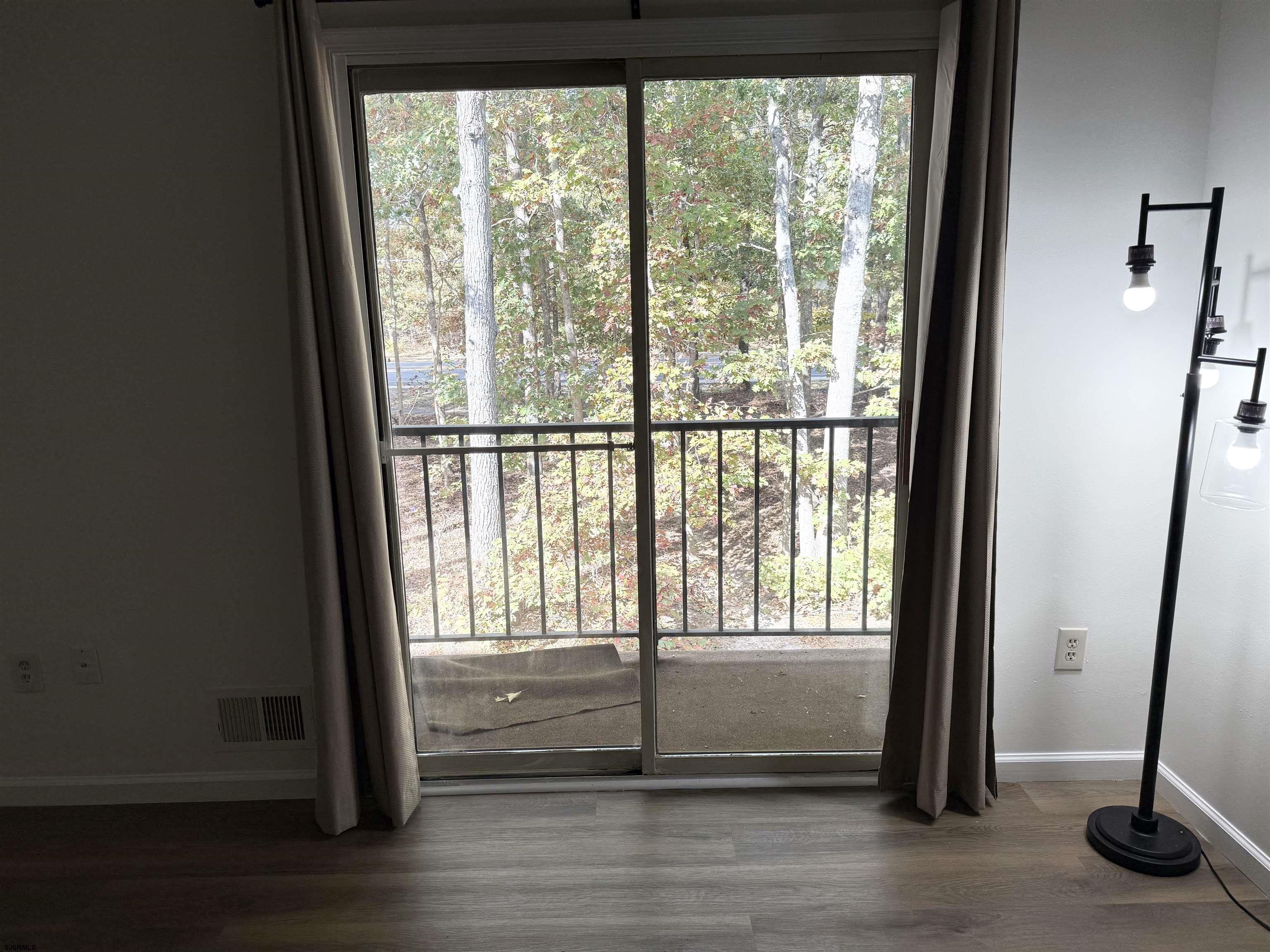 11 Colonial Court, Unit 11 Galloway Township, NJ 08205 - Photo 15 of 15 a view of empty room with wooden floor and fan
