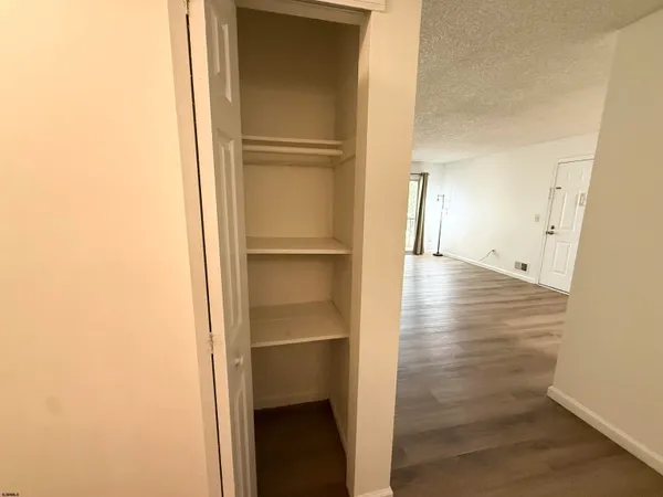 a view of empty room with wooden floor
