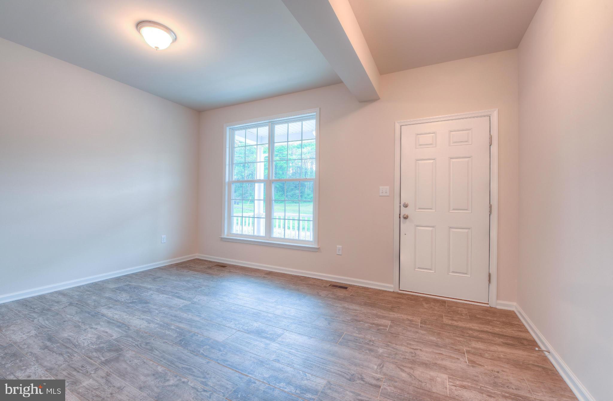 411 Birdie Road Locust Grove, VA 22508 - Photo 14 of 30 an empty room with wooden floor and windows