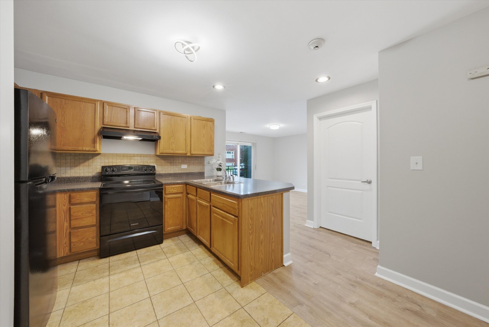 3447 Ridgeland Avenue, Unit 104 Berwyn, IL 60402 - Photo 3 of 12 a kitchen with granite countertop a stove top oven and cabinets