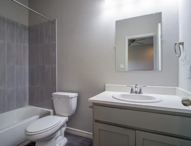 a bathroom with a toilet a sink and mirror