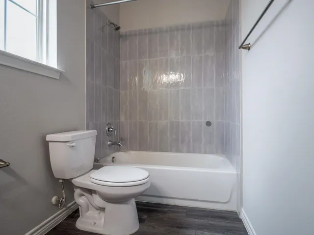 a bathroom with a toilet and a shower