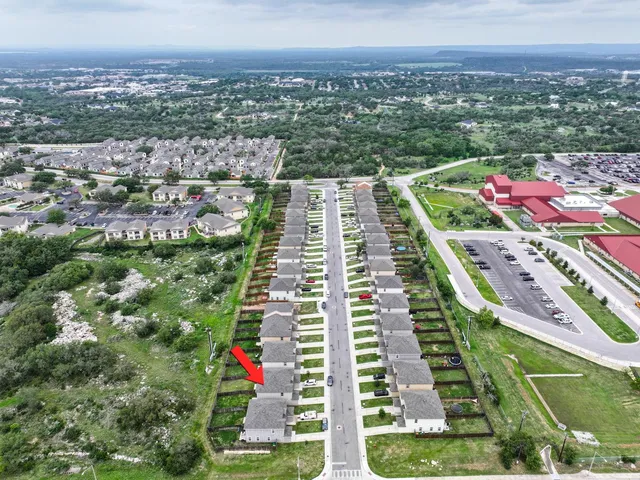 an aerial view of residential houses with outdoor space