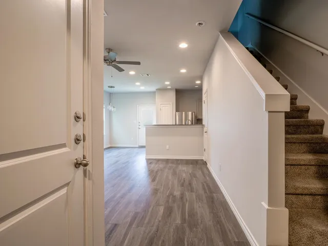 a view of a kitchen from a hallway