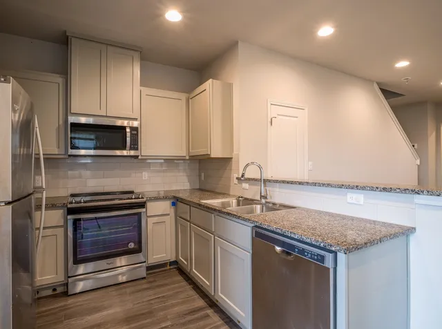 a kitchen with a sink stove and microwave