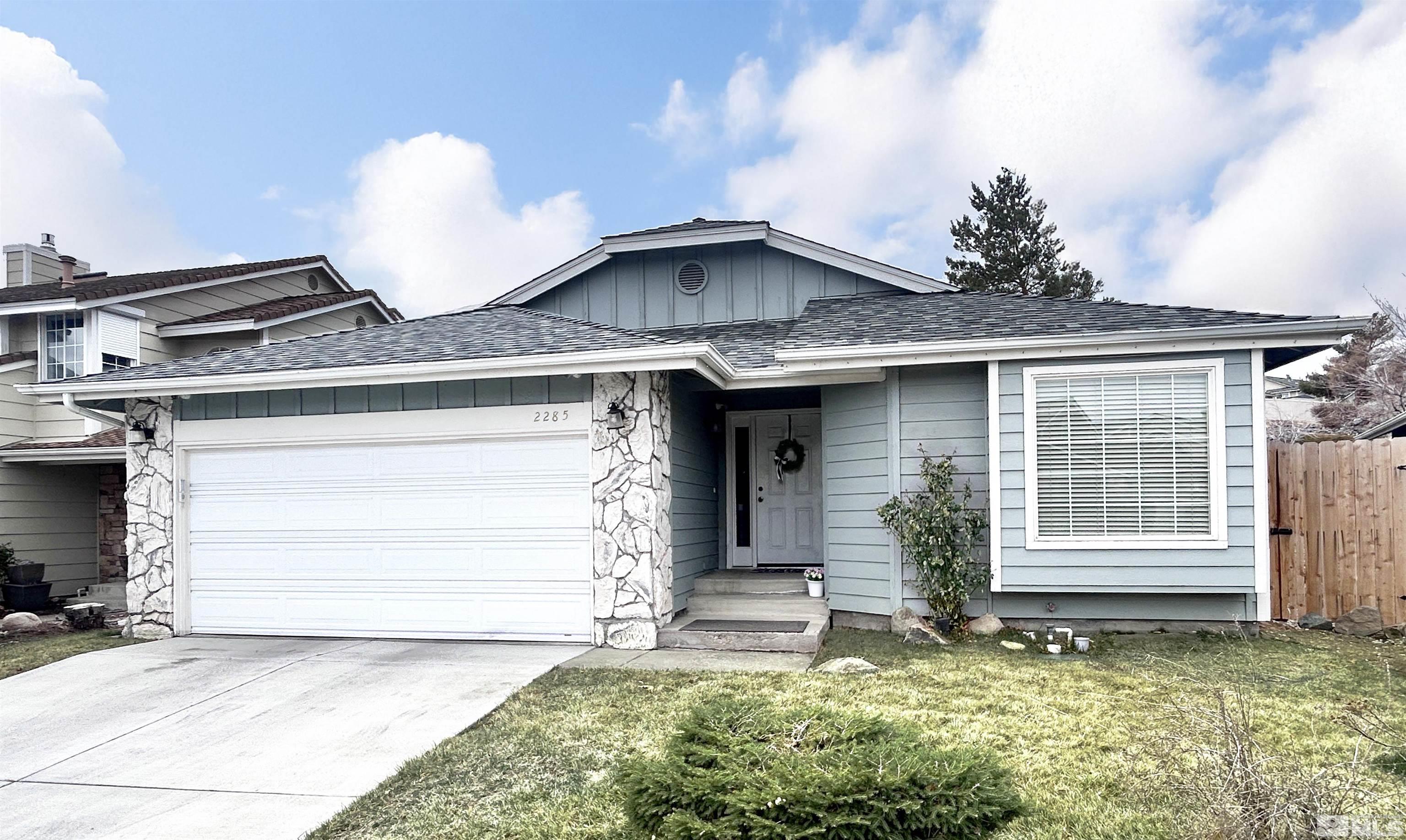 2285 Silver Ridge Drive Reno, NV 89509 - Photo 1 of 19 a front view of a house with a yard