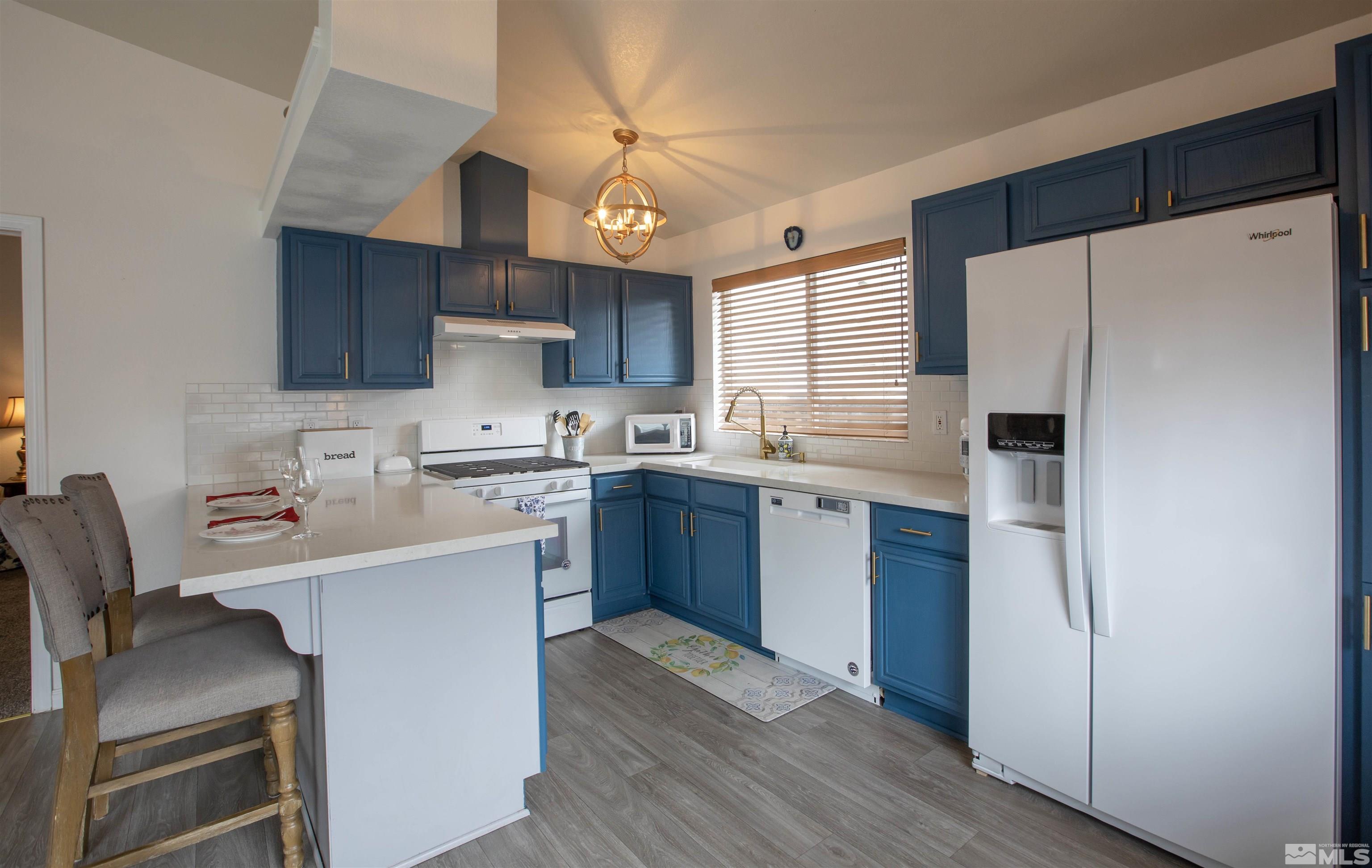 2285 Silver Ridge Drive Reno, NV 89509 - Photo 9 of 19 a kitchen with a sink a stove a refrigerator and cabinets
