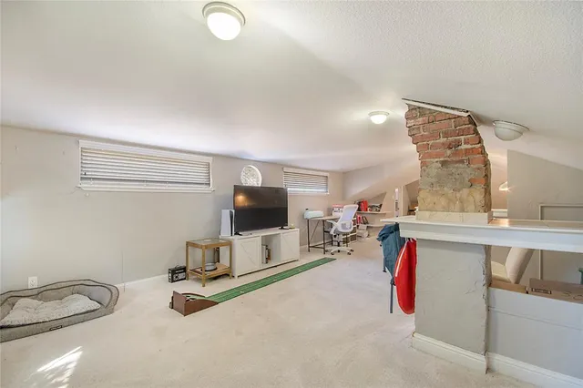 a view of a livingroom with furniture and a flat screen tv