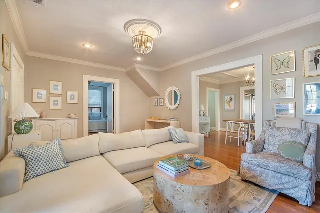 a living room with furniture and a chandelier