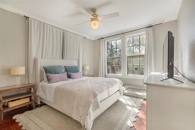 a bedroom with a large bed and a chandelier