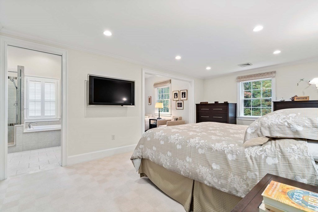8 Whitney Road Newton, MA 02460 - Photo 13 of 25 a spacious bedroom with a bed and a flat screen tv