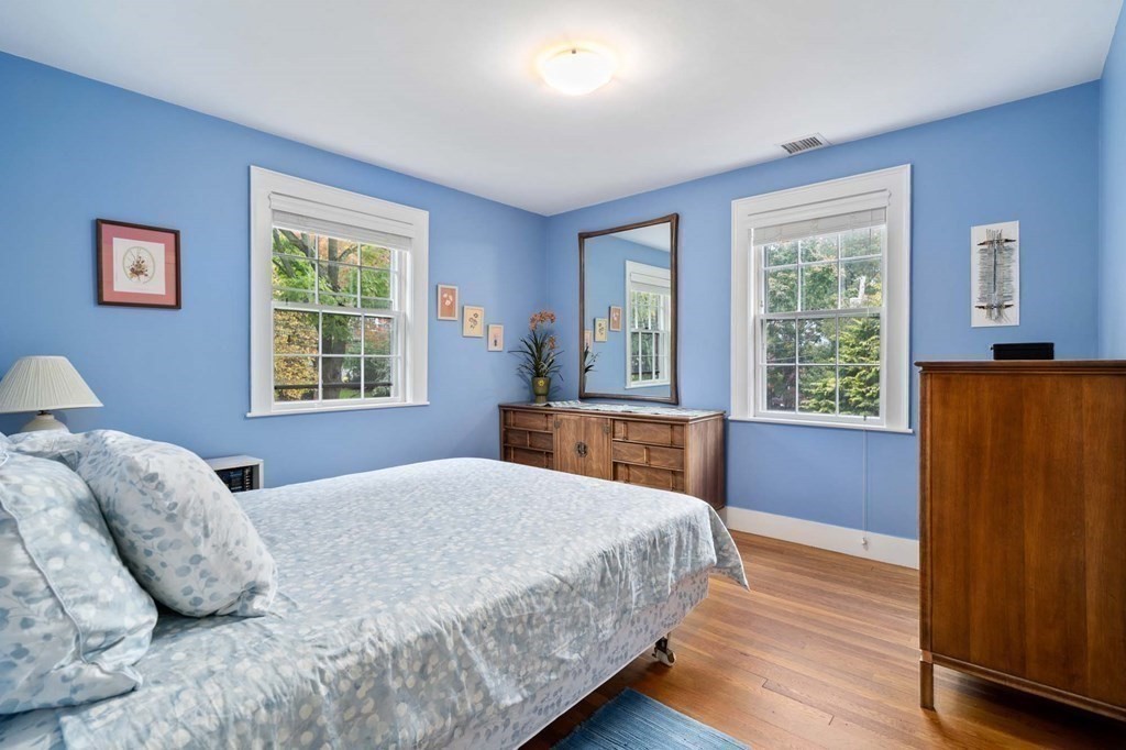 8 Whitney Road Newton, MA 02460 - Photo 17 of 25 a bedroom with a large bed and wooden floor