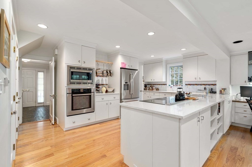 8 Whitney Road Newton, MA 02460 - Photo 3 of 25 a kitchen with stainless steel appliances kitchen island sink refrigerator and cabinets