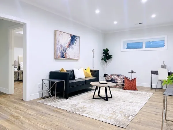 a living room with furniture and wooden floor