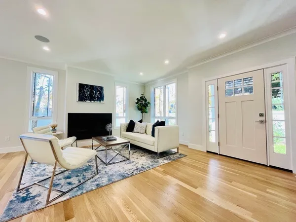 a living room with furniture a fireplace and a flat screen tv