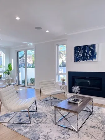 a living room with furniture a rug and a large window