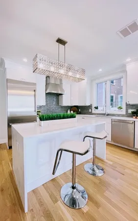 a living room with kitchen island furniture and a wooden floor
