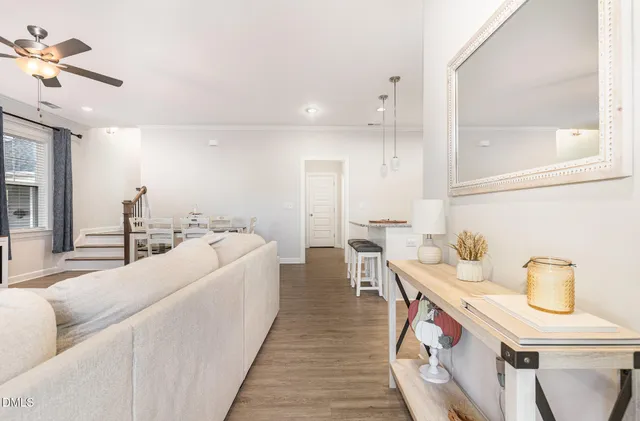 a living room with furniture and a chandelier