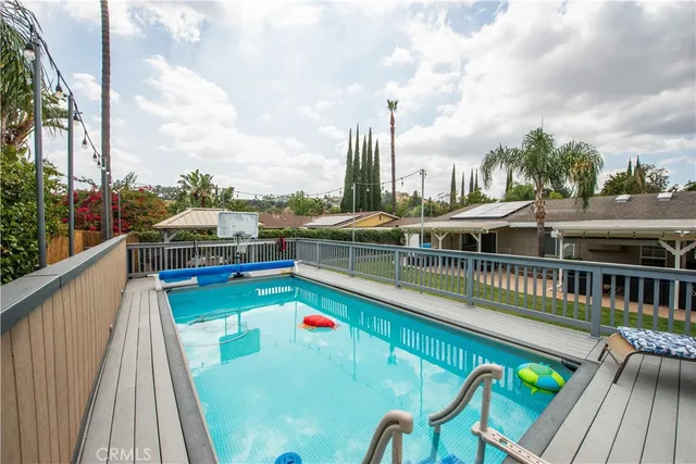 a view of a balcony with wooden floor and outdoor space