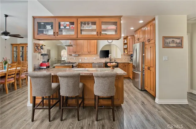 a kitchen with granite countertop a stove and a refrigerator